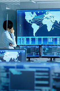 Employee in office analyzing the world map on a smart screen